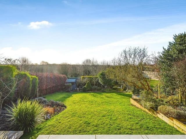 The gorgeous rear garden, which has been elegantly designed by the current owners of the Kirkby property, can be accessed from the kitchen diner, the living room or the garage. As well as the lawn, it includes a shed, a greenhouse and even a cabbage patch.