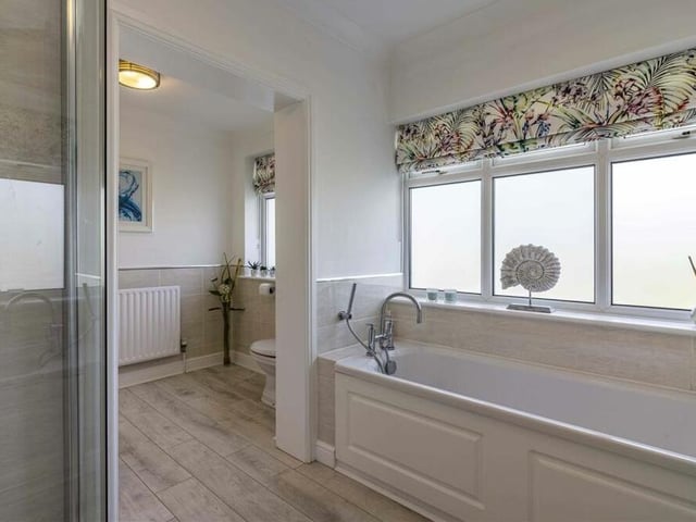 The last of the interior spaces to look at is this family bathroom. A four-piece suite includes a bath and shower cubicle, with a window allowing lots of natural light.