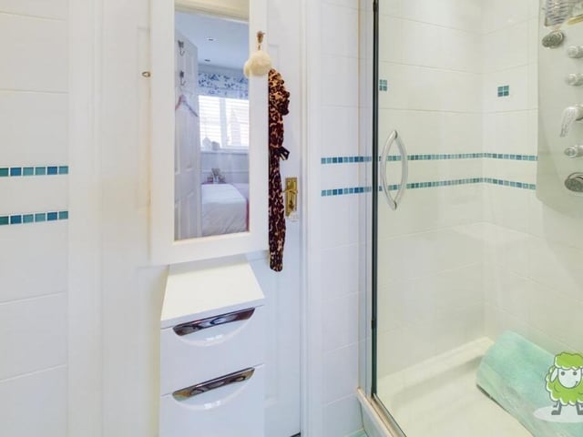 Connecting the two main double bedrooms is this Jack and Jill shower room, complete with shower cubicle.