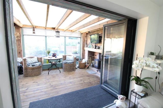 Bi-fold doors give direct access from the lounge to the garden room.
