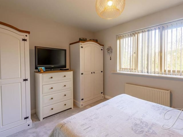 The first bedroom from a different angle, showing there is lots of space for wardrobes and storage.