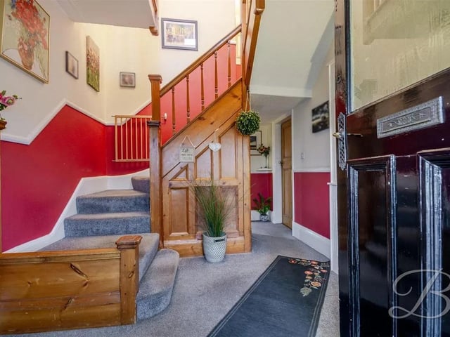 The warm and welcoming entrance way boasts traditional paneling