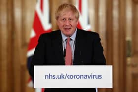 British Prime Minister Boris Johnson holds a news conference addressing the government's response to the coronavirus outbreak (Photo by Simon Dawson-WPA Pool/Getty Images)