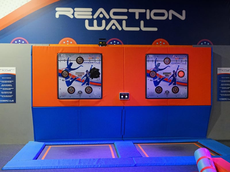 Challenge your friends with a Reaction Wall game. A "Reaction Wall" is an activity that tests a person's reaction speed, hand-eye coordination, and agility by requiring participants to press illuminated targets as quickly as possible.