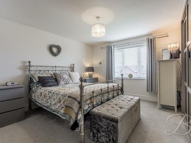 All five of the bedrooms on the first floor are generously-sized, particularly this first one. It features a built-in, walk-in wardrobe with ceiling spotlights, and has access to an en suite shower room.