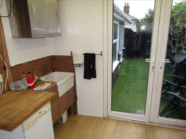 This is the side porch or barbecue room at the Bailey Grove Road bungalow. It boasts a Belfast sink and work surfaces.