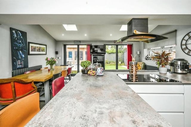 There is space within the kitchen for a lengthy dining table, while bi-folding doors lead to the back garden. A window to the side adds further brightness, while a vinyl laminate floor adds further style.