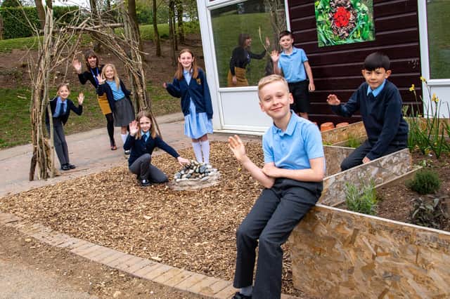 Headteacher Sam Robinson with children of St Mary Magdalene C of E Primary School in their new Garden of Hope