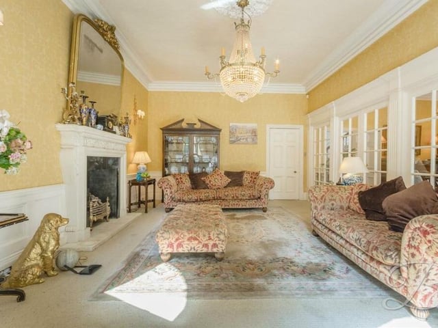 A second shot of the ornate living room, which benefits from fitted carpets. The double doors to the right lead to the dining room.