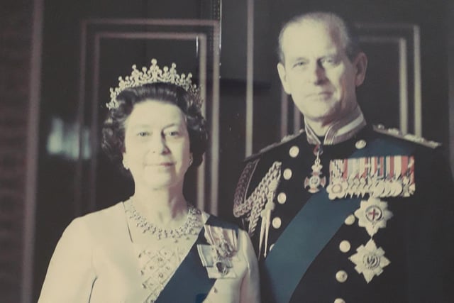 A portrait of Queen Elizabeth II and Prince Philip hangs at Portland College.