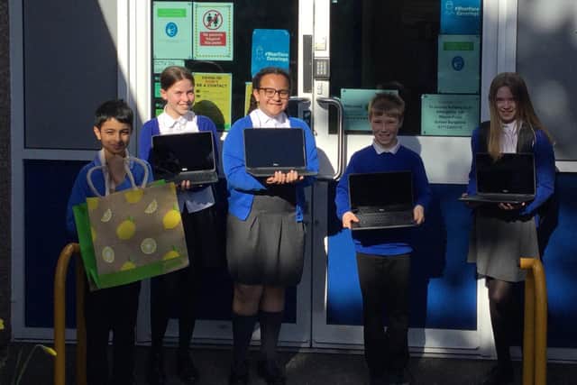 Dalestorth Primary School pupils with their new laptops, donated by Asda.