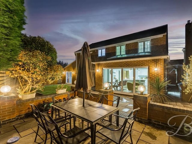 The tranquil rear garden features a low maintenance artificial grass lawn and a patio area.