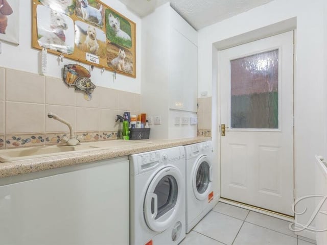 Just off the kitchen is this utility room, which boast a range of fitted units, inset sink, storage cupboard and space and plumbing for a washing machine and tumble dryer. The room also houses a high-capacity combination boiler, fitted as recently as 2021 and with eight years' warranty remaining.