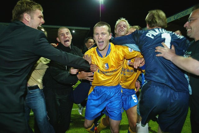 Colin Larkin is mobbed by the fans after scoring the winning penalty to send Mansfield to Cardiff.