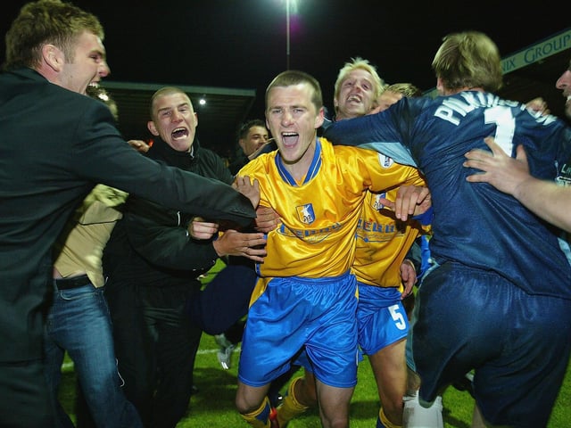 Colin Larkin is mobbed by the fans after scoring the winning penalty to send Mansfield to Cardiff.