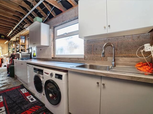 The remarkable 42’6” garage is a standout feature, offering exceptional space for storage, vehicles, and equipment. It includes a fully equipped utility area, an electric garage door, windows for natural light, and direct access to the rear garden.