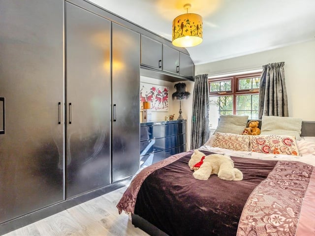 This double bedroom is a real eyecatcher. Facing the front of the £535,000 house, it boasts extensive fitted wardrobes, with hanging rails and shelving, and a laminate floor.