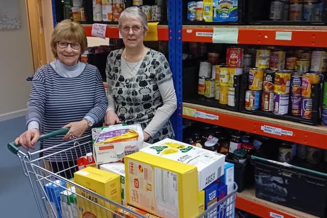 Volunteers Linda and Hazel packing food parcels ready for Friday