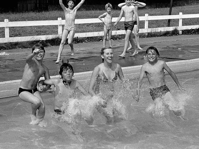 Happy swimmers making a splash in the 80s.