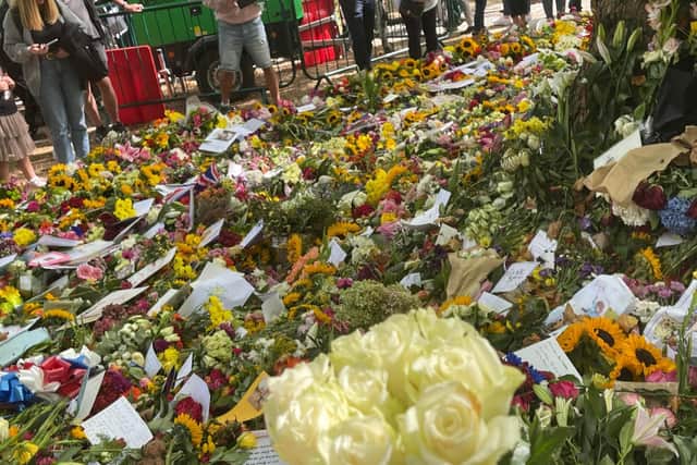 Roses for the queen, placed with thousands of other bouquets.