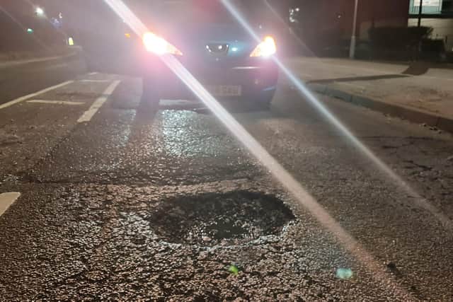 A car approaches a pothole on Hamilton Road in Sutton.