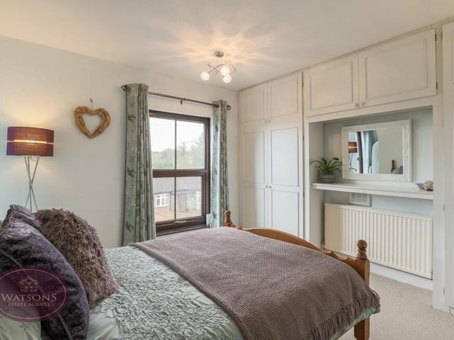 Time to check out the first floor of the £475,000 property where you will find three of the five double bedrooms. This one boasts fitted wardrobes, storage and furniture and overlooks the front of the house.