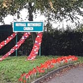 Drapes of poppies from the Nuthall church sign. Photo: Submitted