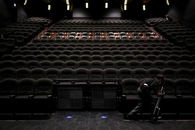 An employee cleans seats at a cinema following measures to curb the spread of COVID-19, June 5, 2020.