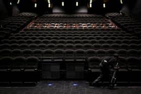 An employee cleans seats at a cinema following measures to curb the spread of COVID-19, June 5, 2020.