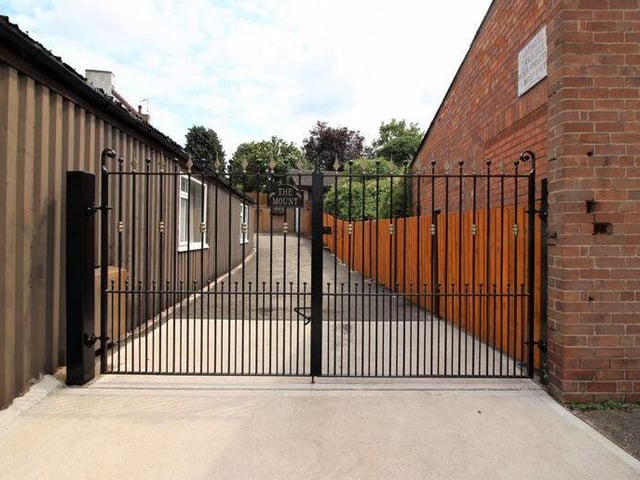 This gated access to an extensive driveway offers privacy and security for the Ollerton property.