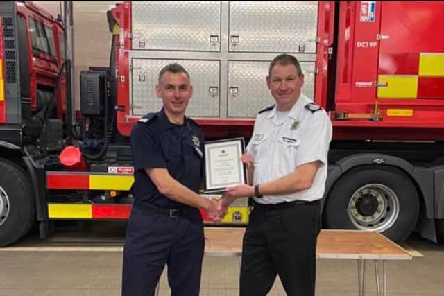 Firefighter Graham Jackson (left) retires at the Ashfield Fire Station. He receives a certificate from NFRS chief fire officer John Buckley.