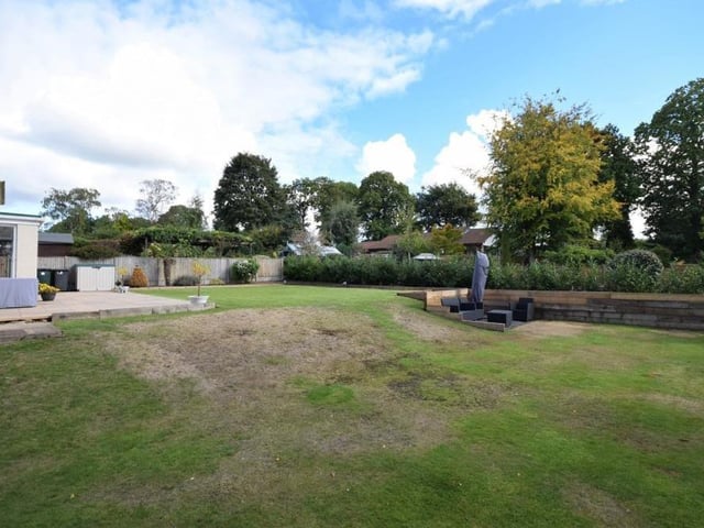 An image showing the expanse of lawn at the back of the £550,000-plus Ravenshead property.