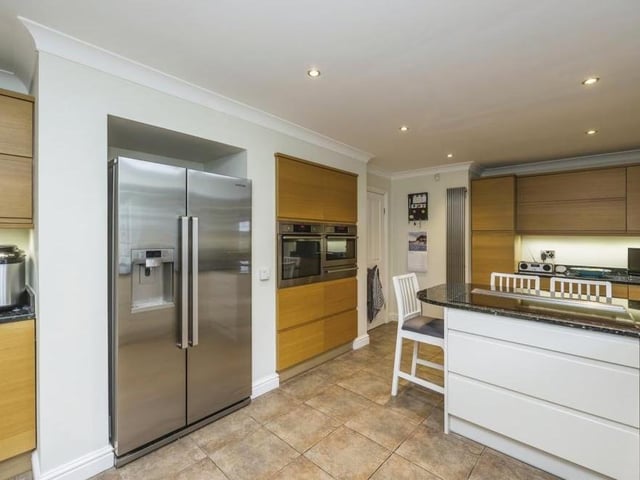 The breakfast kitchen at the £475,000 bungalow is a stunner, with its breakfast bar, tiled flooring and space for an American-style fridge/freezer. Integrated appliances include a single electric combi oven/microwave, warming drawer, induction hob with discreet extractor fan, washing machine and dishwasher.