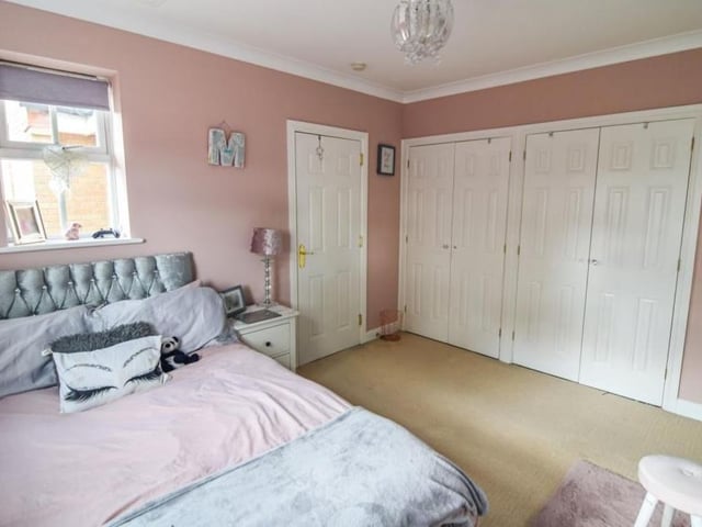 The first bedroom at the £650,000-plus property features an impressive bank of fitted wardrobes.