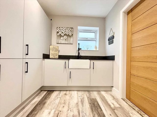 The utility room offers washing facilities to include wash basin, washing machine and tumble dryer.