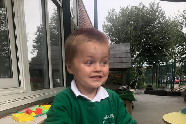 Cameron, three, playing outside.