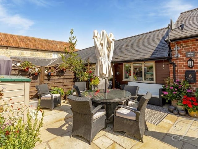 Take a seat in the sunshine on this patio area.