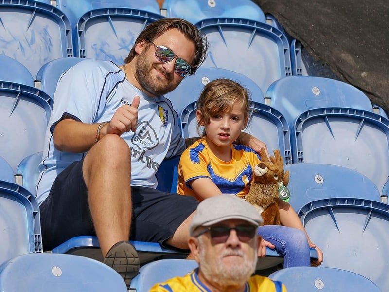 Mansfield Town fans watch the 1-1 draw at Colchester United on 16 Sept 2023.