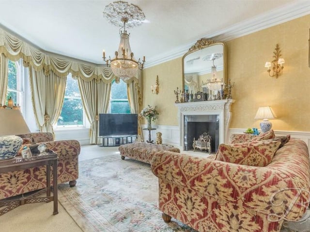 Our first port of call on the ground floor is this lovely living room, which sets the traditional tone for the rest of the house. It has a terrific feature fireplace and a bay window that allows a wealth of natural light through. Double doors lead into the dining room.
