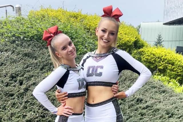 Wren (left) and Ellie in their full cheerleading uniform
