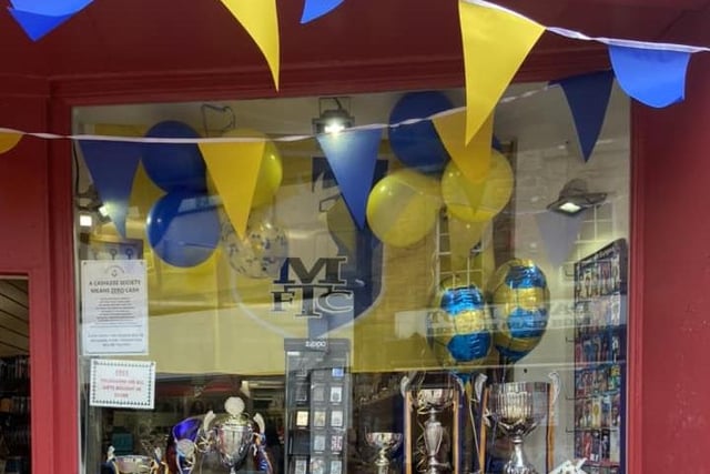 Mansfield Shoe Repairs, on West Gate, have put up the blue and yellow bunting in celebration and support.