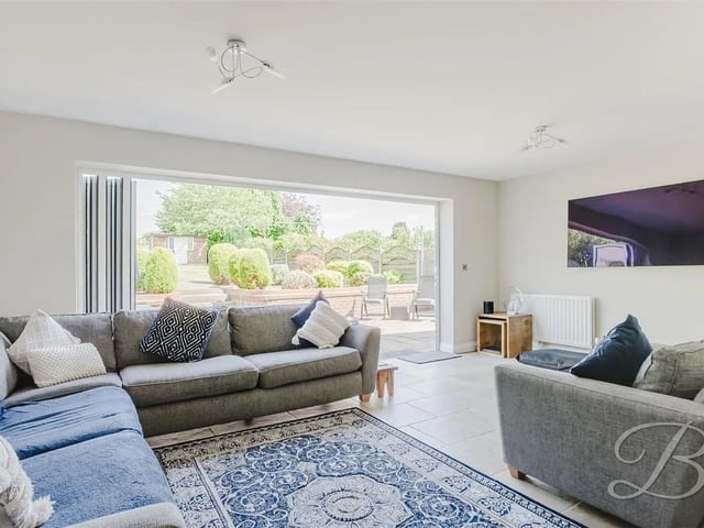 Generous living area featuring a stunning open-plan layout with bi-folding doors that lead out to the rear garden, seamlessly blending indoor and outdoor living.