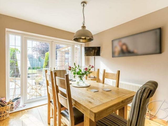 More patio doors to the garden can be found in the dining room, which is a bright and pleasant space for family meals.