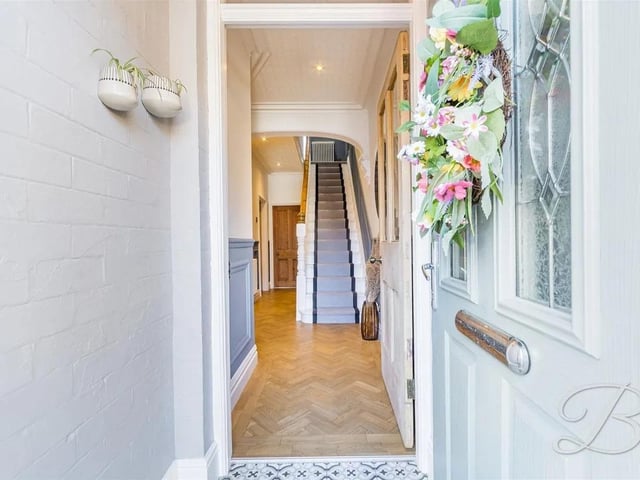 A warm welcome awaits with an inviting hallway providing a storage cupboard under the stairs.