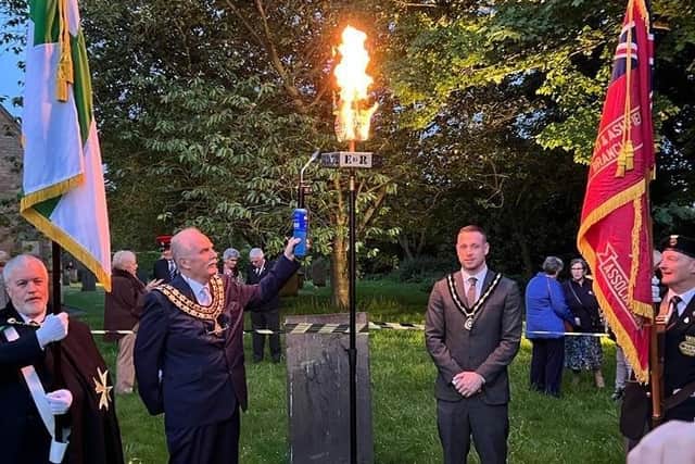 Coun David Walters, chairman of Ashfield District Council, lights the beacon, with vice-chairman Coun Dale Grounds