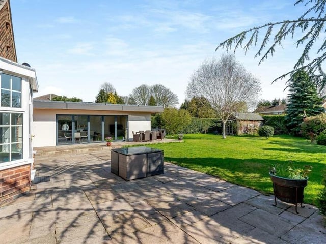 Time to step outside now, with particular focus on the south-facing back garden that features a central lawn and an L-shaped sandstone patio on two levels.