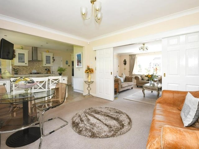 We move on now to the kitchen/diner, which is spacious and high-spec. The kitchen is in the background, while the dining area is in the foreground. Sliding doors lead to the lounge.