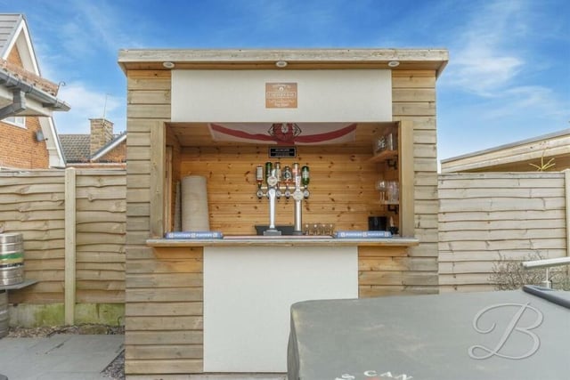 A standout feature of the back garden is this pretty, home-made bar. Whose round is it?