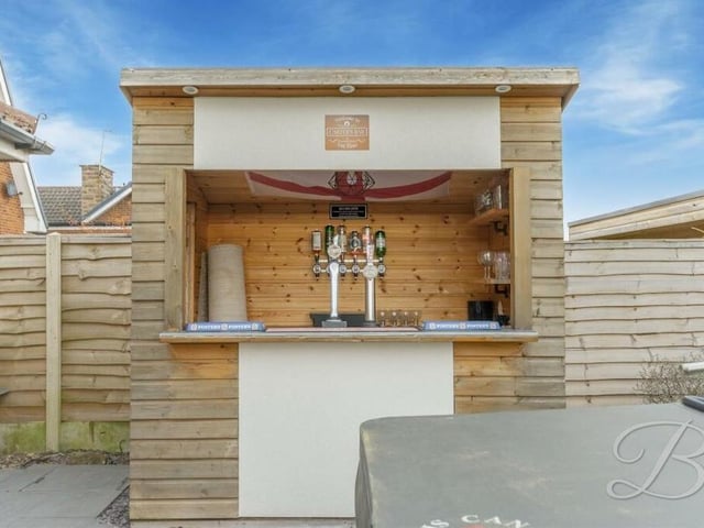 A standout feature of the back garden is this pretty, home-made bar. Whose round is it?