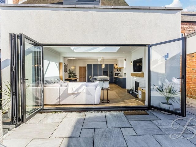 The bi-folding doors open seamlessly into the rear garden, providing a perfect indoor-outdoor flow.